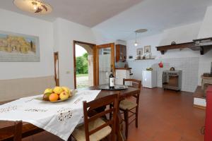 a kitchen with a table with a bowl of fruit on it at Casa Vacanze Podere Ugolini in Ronta
