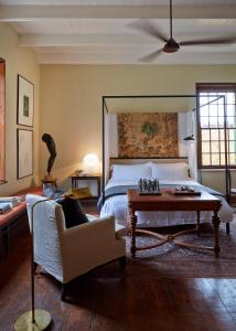 a bedroom with a bed and a table and a couch at Jonkmanshof - 20 Bath in Montagu +34 photos