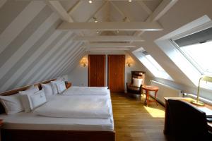 a bedroom with a large white bed in a attic at Hotel Savoy Hannover in Hannover
