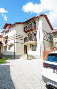 a house with a car parked in front of it at Chez Marcel Sinaia in Sinaia