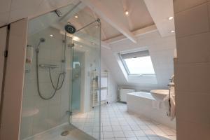 a bathroom with a shower and a sink at Hotel Savoy Hannover in Hannover