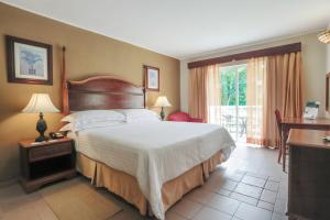 a hotel room with a bed and a desk at Occidental Caribe - All Inclusive (former Barcelo Punta Cana) in Punta Cana