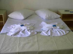 En eller flere senge i et værelse på Hotel Pousada Mineirinho
