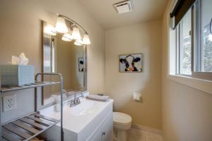 a bathroom with a sink and a toilet and a mirror at Apache Greens in Sisters +23 photos