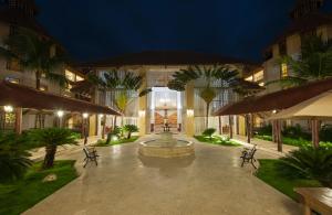 a courtyard with a fountain in the middle of a building at Occidental Caribe - All Inclusive in Punta Cana