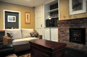 a living room with a couch and a fireplace at Killilagh Accommodation in Doolin