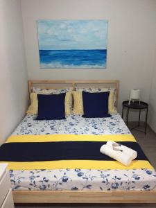 1 dormitorio con 1 cama con sábanas azules y amarillas en Terra e Mare, en Capaci