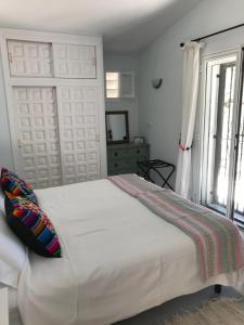 sypialnia z dużym białym łóżkiem i oknem w obiekcie Villa Margarita w mieście Turre