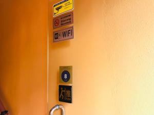 a bathroom door with signs on the wall at Home Inn Hotel in Ipoh