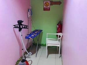 a corner of a room with a table and a chair at Home Inn Hotel in Ipoh