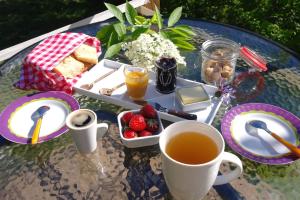 un tavolo con vassoio di cibo e una tazza di tè di le cri de la yourte a Saint-Urcisse