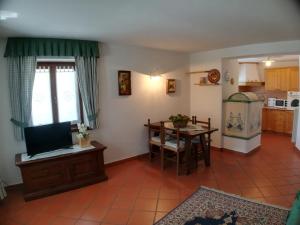 a living room with a kitchen and a dining room at CASA BRENZ in Madonna di Campiglio