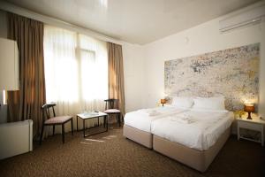Postel nebo postele na pokoji v ubytování Pawlonia Villa Kvareli