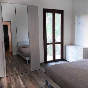 a bedroom with a mirror and a bed and a bed sidx sidx sidx at Casa Lin in Celle Ligure