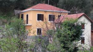 a yellow house with a red roof at Casa Lin in Celle Ligure +11 photos