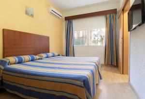 Łóżko lub łóżka w pokoju w obiekcie Hotel Palia La Roca
