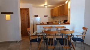 a kitchen with a table and chairs and a refrigerator at Pogonitsa in Kotrónion