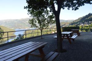 a group of benches sitting on top of a hill at Casa São Bernardo de Claraval in Geres