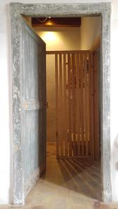 an open doorway to a room with a wooden door at BORGO PETELIA, Casa Chiarotti, Antica casa con scala esterna in Strongoli