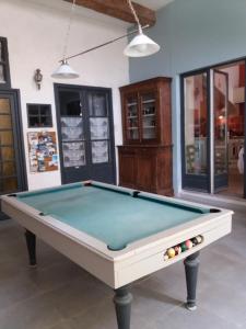 a pool table in the middle of a room at Le Patio Des Cigales in Roquefort-des-Corbières