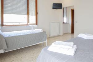 Postel nebo postele na pokoji v ubytování B&B Alba sul Mare Guest House
