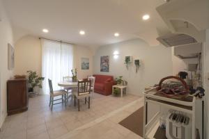 a kitchen and living room with a table and a couch at Le Dimore del Duomo in Catania