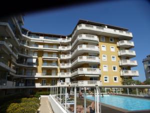 a large building with a swimming pool in front of it at Palais des Domes Gloria in Nice