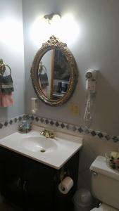 a bathroom with a sink and a mirror and a toilet at Midway Lodging in Cornish +26 photos