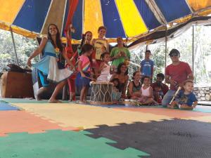 a group of people posing for a picture in a tent at Ilha de Mato in Vale do Capao