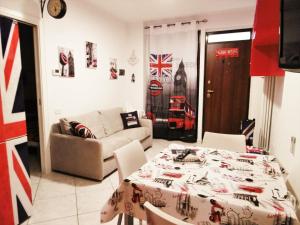 a living room with a table and a couch at LONDON BY SEA in Porto Recanati