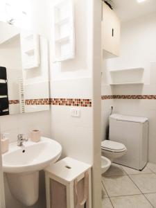a white bathroom with a sink and a toilet at LONDON BY SEA in Porto Recanati