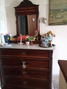 a wooden dresser with a sink and a mirror at L'apparita Camere in Pienza +92 photos