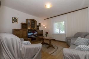 a living room with a couch and a tv at Vacation Home Petar in Makarska