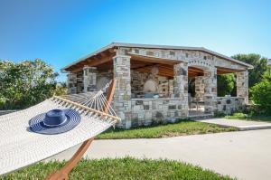 a hammock in front of a stone house at Summer Memories Studios in Naxos Chora
