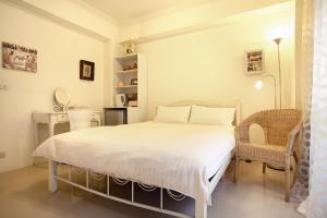 a bedroom with a bed and a table and chairs at RaRa Stay in Taichung
