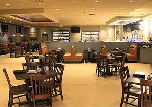 a dining room with tables and chairs and a restaurant at Isle Casino Hotel Lula, A Caesars Destination in Lula