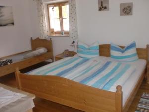a bedroom with a large bed with blue pillows at Schönfeldjoch in Bayrischzell