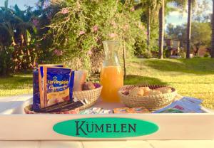 a table with food and a jug of orange juice at Cabañas Kumelen Resort in Termas de Río Hondo