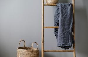 a wooden ladder with a towel and a basket at Hotel Isbolaget in Donsö