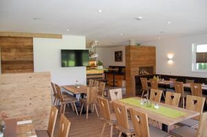 a dining room with wooden tables and chairs at Villa Landlust in Sankt Leonhard +20 photos
