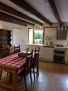 a kitchen with a table and chairs in a room at Lower Thura House in Wick