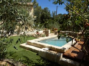 a swimming pool in a yard with a garden sidx sidx sidx at Gite de la Coste in Langlade