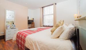 a bedroom with a large bed and a window at Breeze Guest House in Bootle