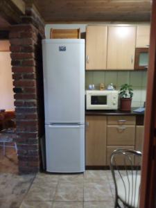 a kitchen with a white refrigerator and a microwave at u Vlastika in Jeseník