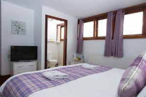 a bedroom with a bed with two towels on it at Breeze Guest House in Bootle