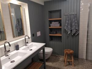 a bathroom with a sink and a toilet at Østigård 1810 Gamlehuset in Åndalsnes +36 photos