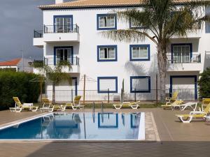 a hotel with a swimming pool in front of a building at Altura Beach AL in Altura