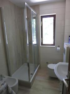 a bathroom with a shower and a toilet and a sink at Apartment Stella in Malinska