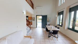 a dining room with a table and chairs in a house at Villa Anna in Asprouliánoi