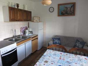 a small kitchen with a sink and a table at Apartment Stella in Malinska